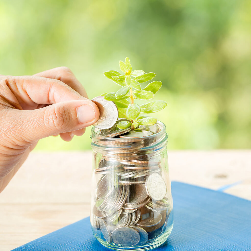 close up of a coin jar with a tree
